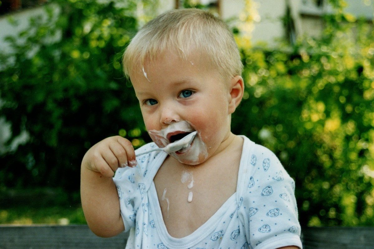 Healthy boy eating yoghurt